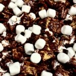 Melted chocolate and marshmallows cover golden grahams ceral