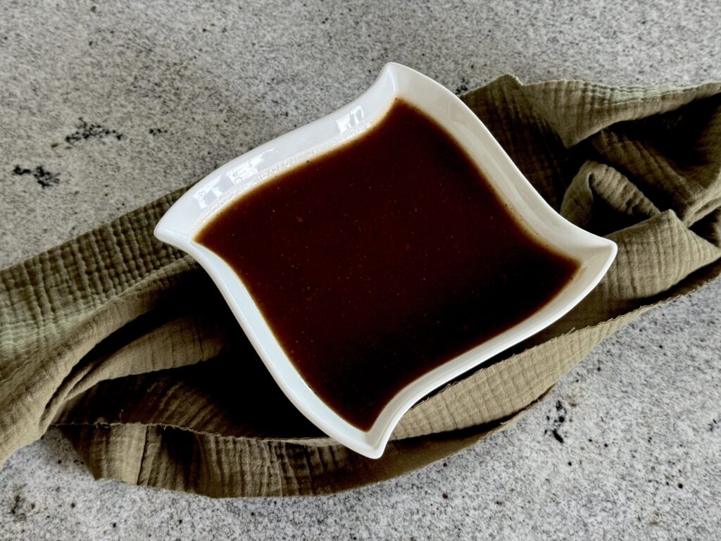 Brown gravy in white bowl