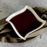 Brown gravy in white bowl