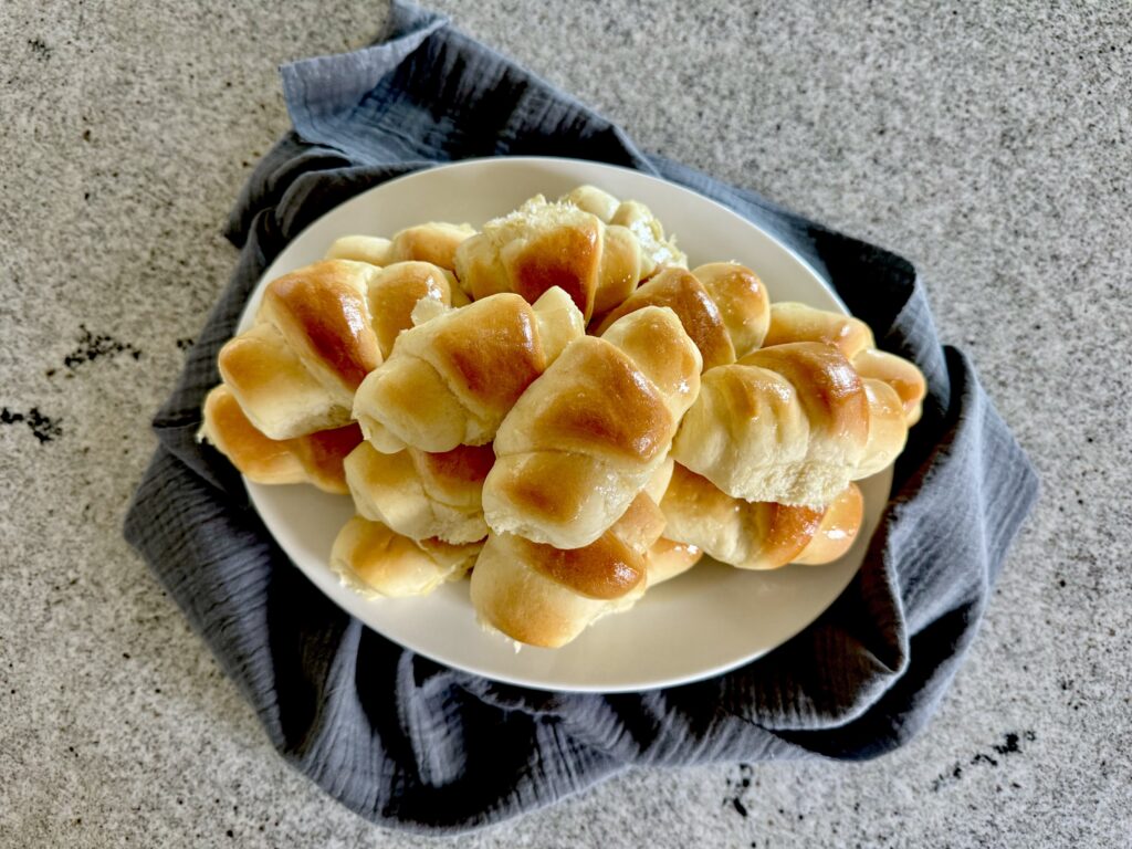 Dinner rolled piled on plate.