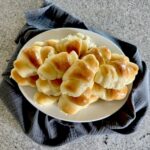 Dinner rolled piled on plate.