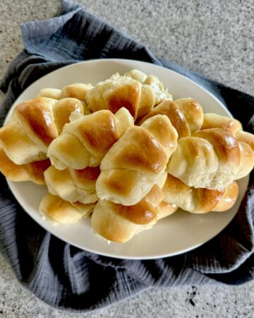 Dinner rolled piled on plate.